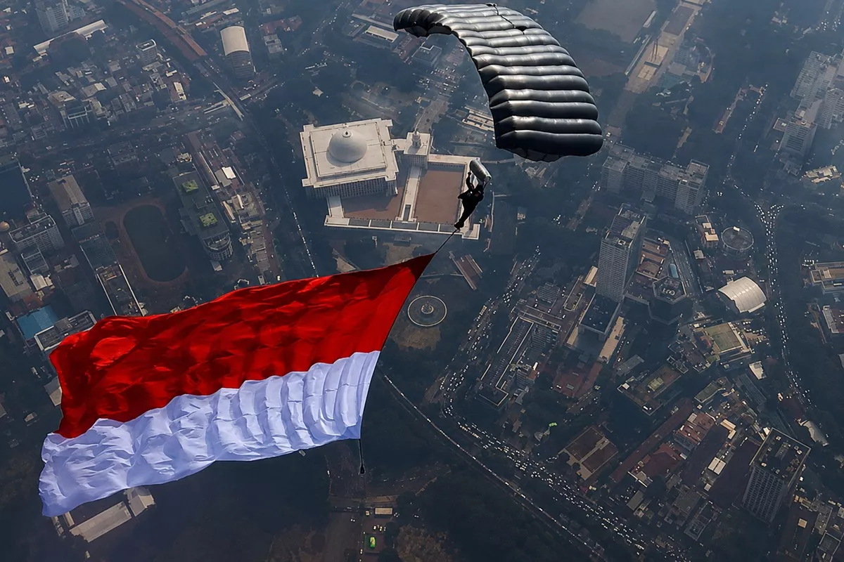 17 Penerjun Kopassus Terjun dari 10.000 Kaki, Bendera Raksasa Berkibar di Langit Monas