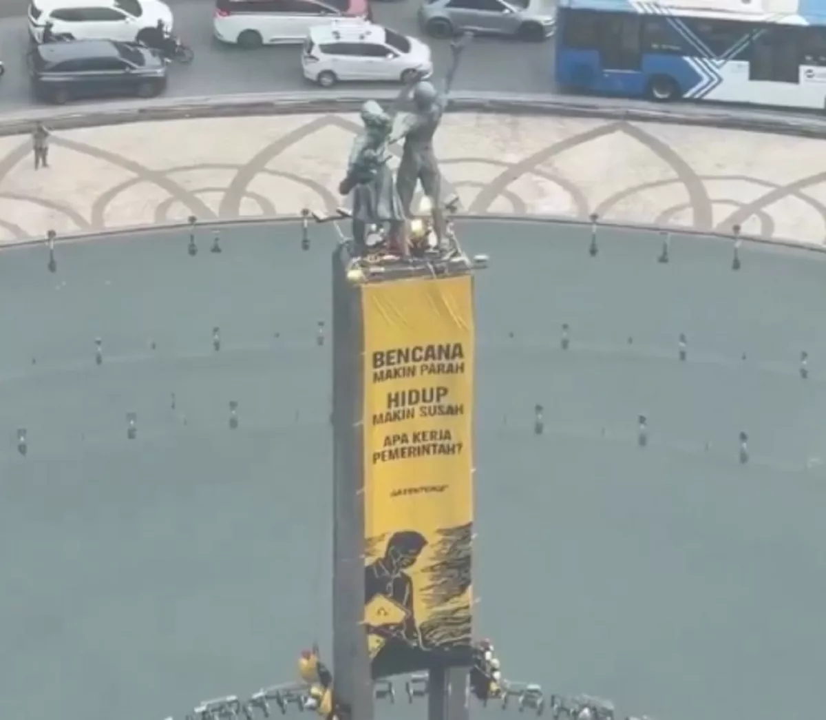 Panjat Patung Bundaran HI, Greenpeace Membentang Baliho 'Hidup Makin Susah'!